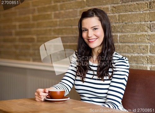Image of Attractive Woman in Cafe with Coffee