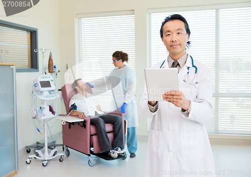 Image of Doctor With Digital Tablet In Chemo Room