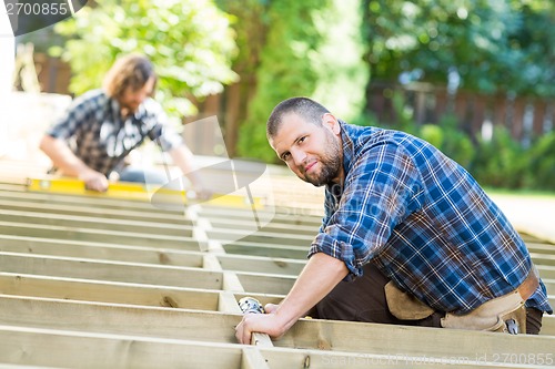 Image of Carpenter Working At Construction Site