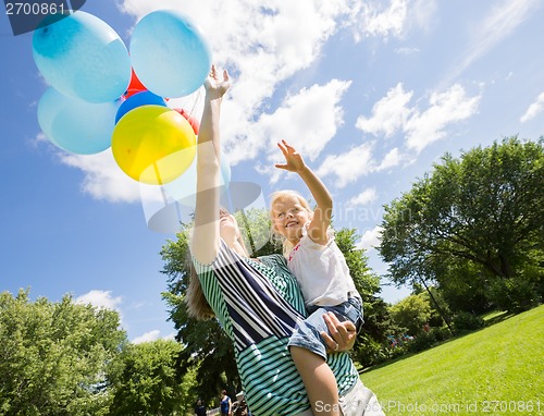 Image of Mother And Daughter With Balloons In Park