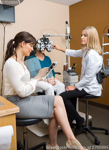 Image of Optometrists Examining Patient At Store