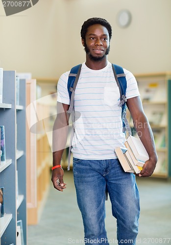 Image of Student With Books Looking Away In Library