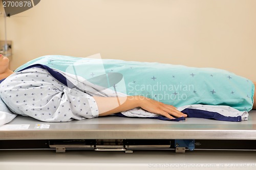 Image of Patient Lying On Xray Table