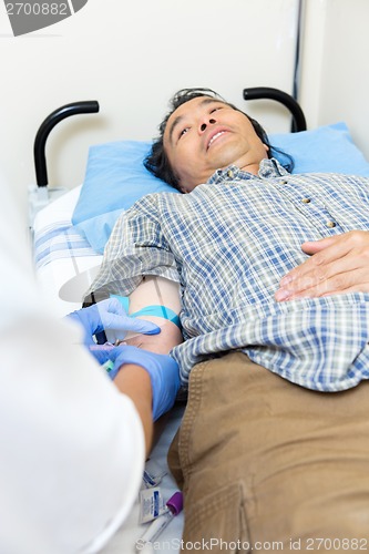 Image of Doctor Drawing Blood From Patient's Arm