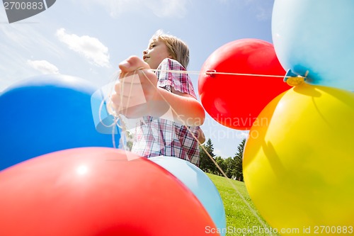 Image of Boy With Colorful Balloons Running In Park