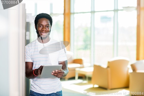 Image of Student With Digital Tablet Standing In Library