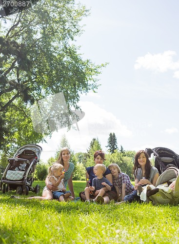 Image of Female Friends With Their Children Enjoying Picnic