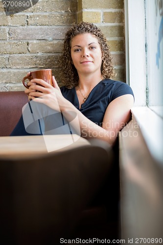 Image of Woman Holding Coffee Cup In Cafeteria