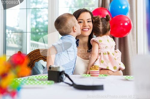 Image of Birthday Boy Kissing Mother At Home