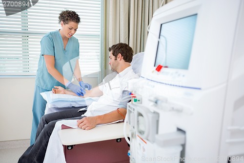 Image of Nurse Injecting Patient For Renal Dialysis Treatment