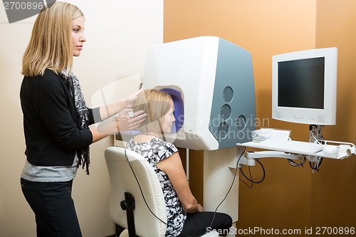 Image of Optometrist With Patient Looking At Computer For Retinal Checkup