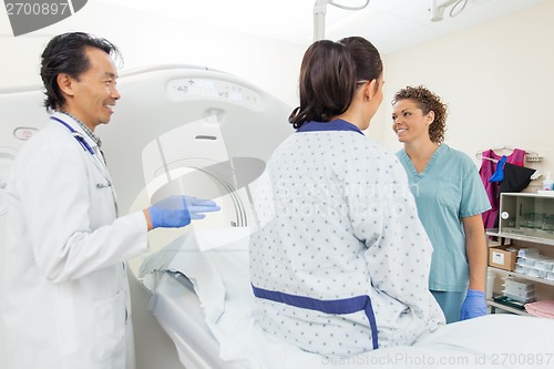 Image of Medical Team With Patient In CT Scan Room