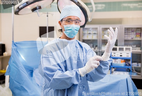 Image of Surgeon Wearing Gloves In Operation Room