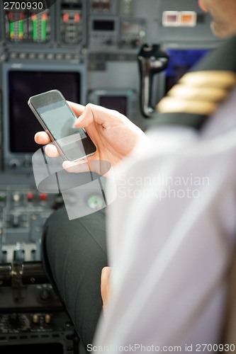 Image of Pilots Using Smartphone In Cockpit