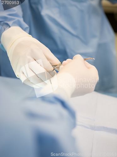 Image of Surgeons Passing Scissors During Surgery
