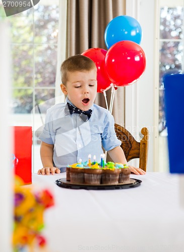 Image of Boy With Mouth Open Looking At Cake
