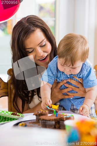 Image of Mother With Baby Boy Eating Cupcake