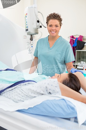 Image of Nurse With Patient In CT Scan Room