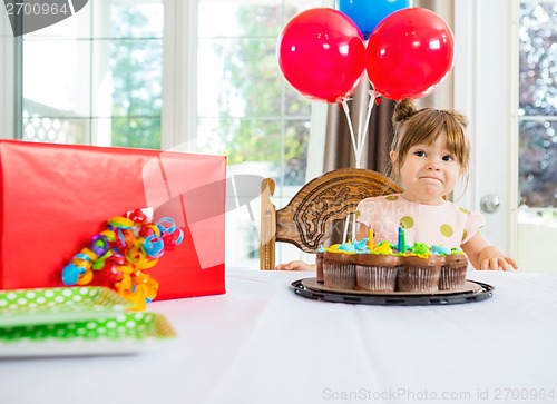 Image of Birthday Girl With Cake And Present On Table