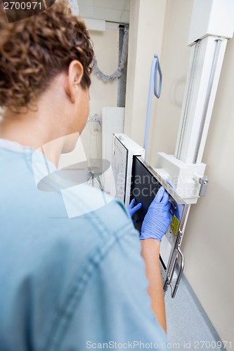 Image of Nurse Adjusting Xray Film In Machine