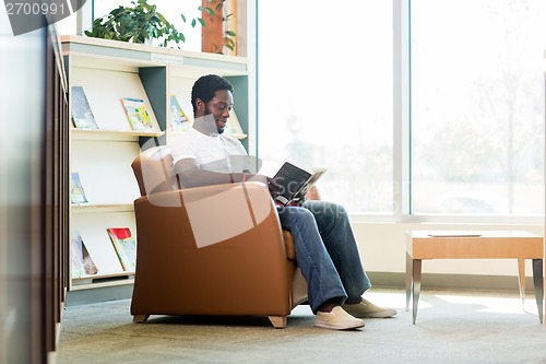 Image of Student Reading Book In Bookstore