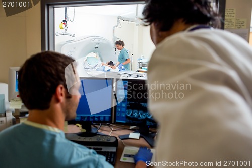 Image of Medical Team Operating Computers In CT Scan Lab