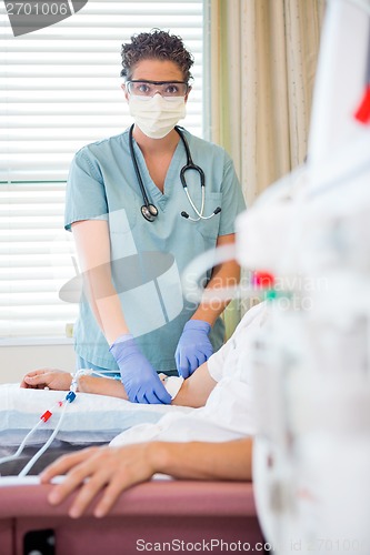 Image of Nurse Starting Renal Dialysis on Patient