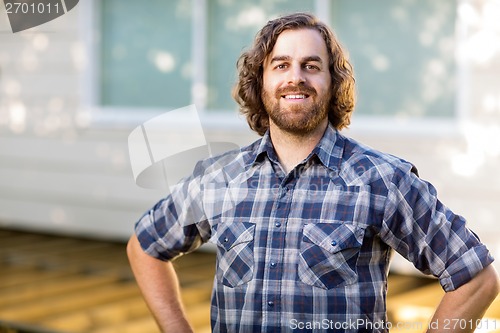 Image of Confident Carpenter Standing At Construction Site