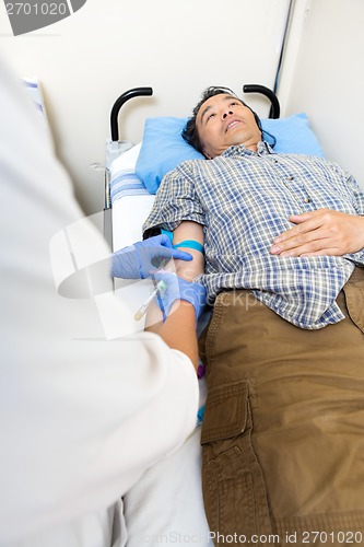 Image of Doctor Drawing Blood From Patient's Arm