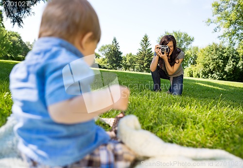 Image of Woman Photographing Baby Boy In Park