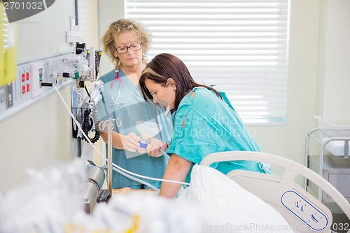 Image of Nurse Giving Nitroud Oxide Mask to Pregnant Woman