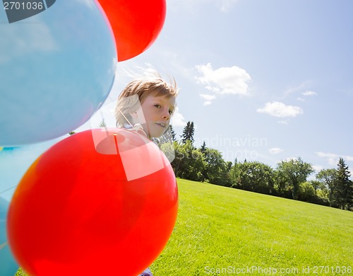 Image of Boy With Balloons In Park