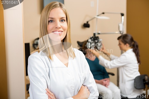 Image of Eye Specialist With Colleague Examining Patient