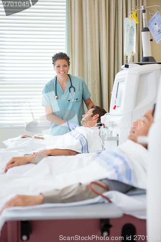 Image of Nurse Standing By Patient Undergoing Renal Dialysis