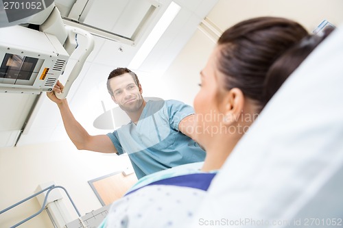 Image of Male Nurse Adjusting Xray Machine For Patient