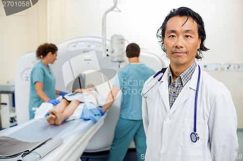 Image of Radiologist With Nurses Preparing Patient For CT Scan Test