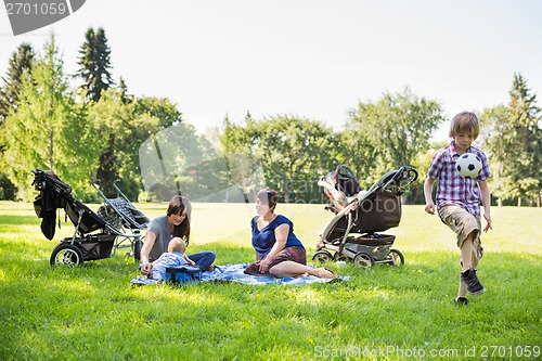 Image of Mothers With Children Enjoying Picnic