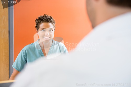 Image of Nurse Looking At Patient In Hospital