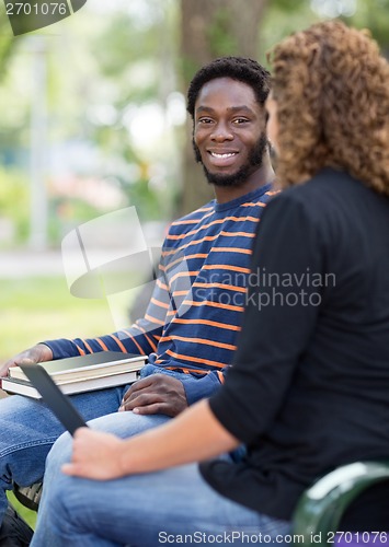 Image of Students Sitting On University On Campus