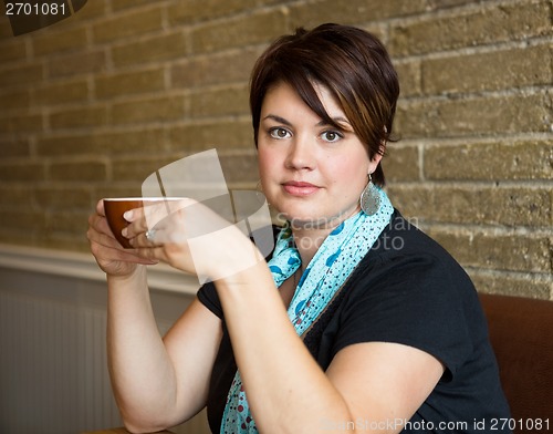 Image of Beautiful Woman Holding Coffee Cup In cafe