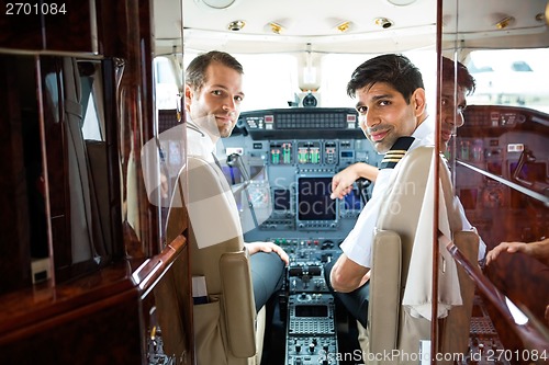 Image of Pilots In Corporate Plane Cockpit