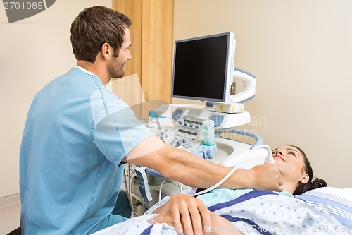 Image of Male Nurse Performing Ultrasound On Patient's Neck