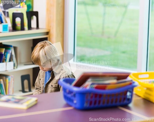Image of Boy Reading Book In Library