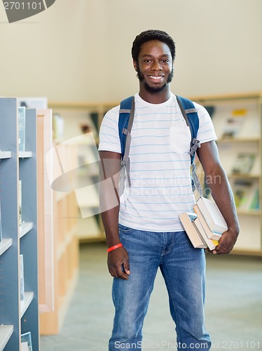 Image of Student With Books Standing In Bookstore