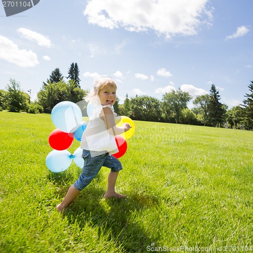 Image of Girl With Colorful Balloons Running In Meadow