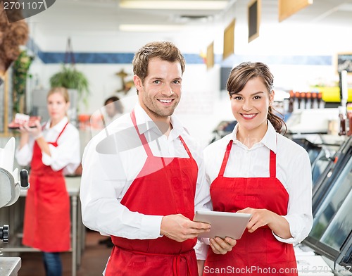 Image of Butchers With Digital Tablet Standing In Store