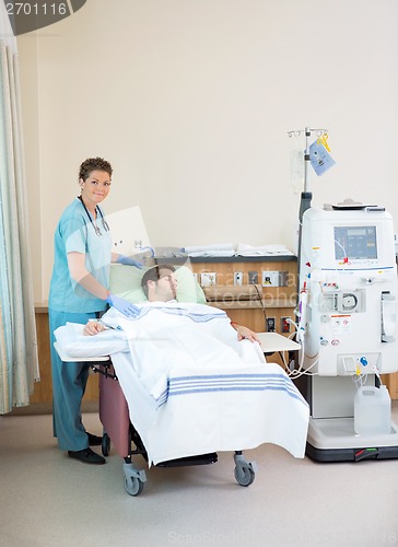 Image of Portrait Of Nurse Standing By Patient Receiving Dialysis