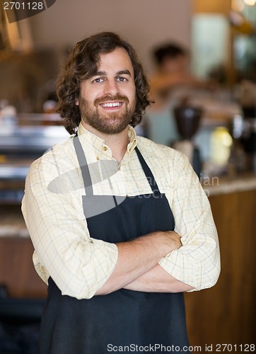 Image of Male Owner Standing Arms Crossed In Cafeteria