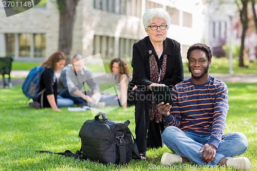 Image of Professor Helping Student on Digital Tablet