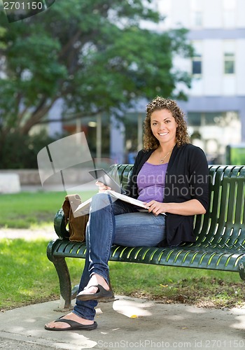 Image of Confident Student Studying On Bench At Campus